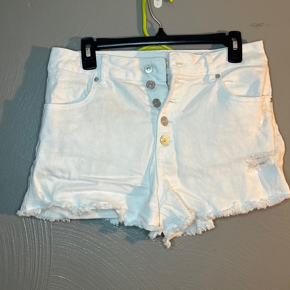 White button-up, high waist shorts.